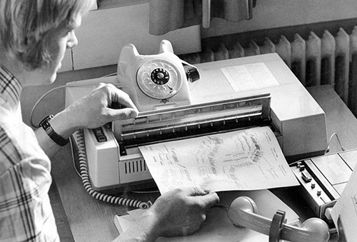 File photo of a person using an early telefax machine