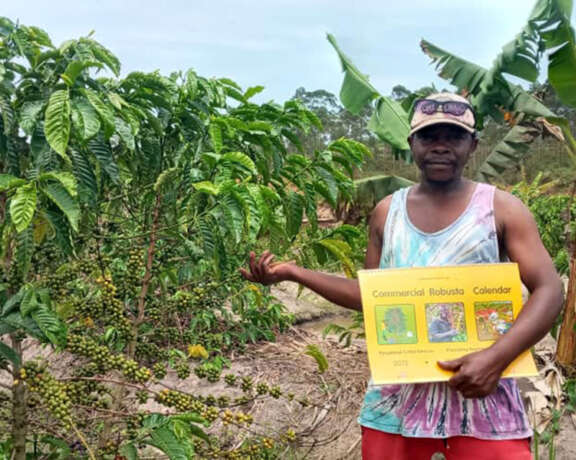 Coffee farmer Hakim holds his robusta calendar