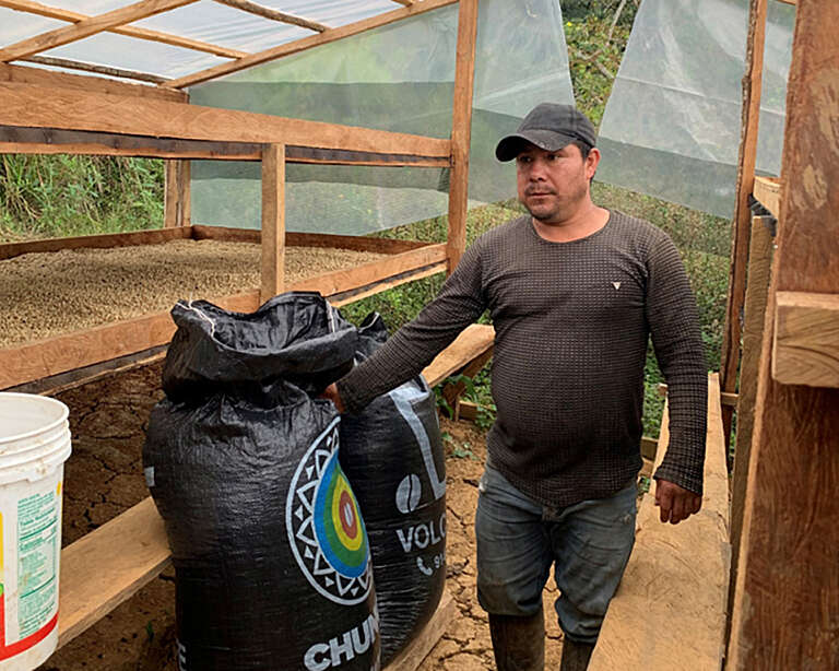 A man working inside a solar dryer in Peru.