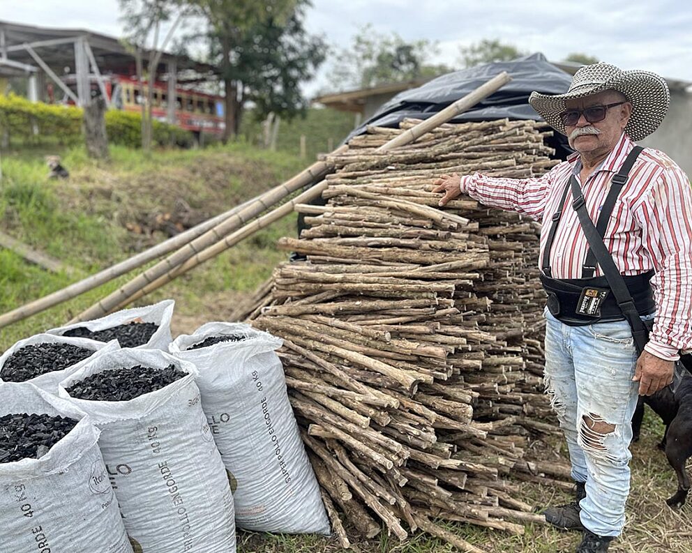Colombian farmer with biomass materials and biochar